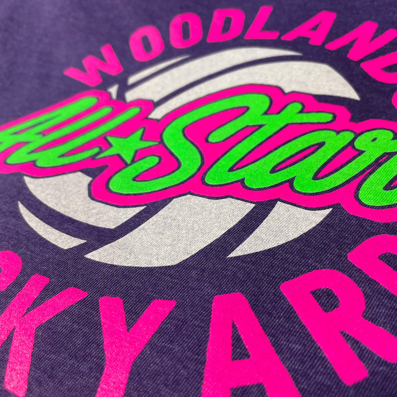Custom Print Detail of Neon Pink and Green Ink on a Purple T-Shirt for Woodlands Backyard Volleyball Leagues as designed and printed by Mysterioso Rock Art