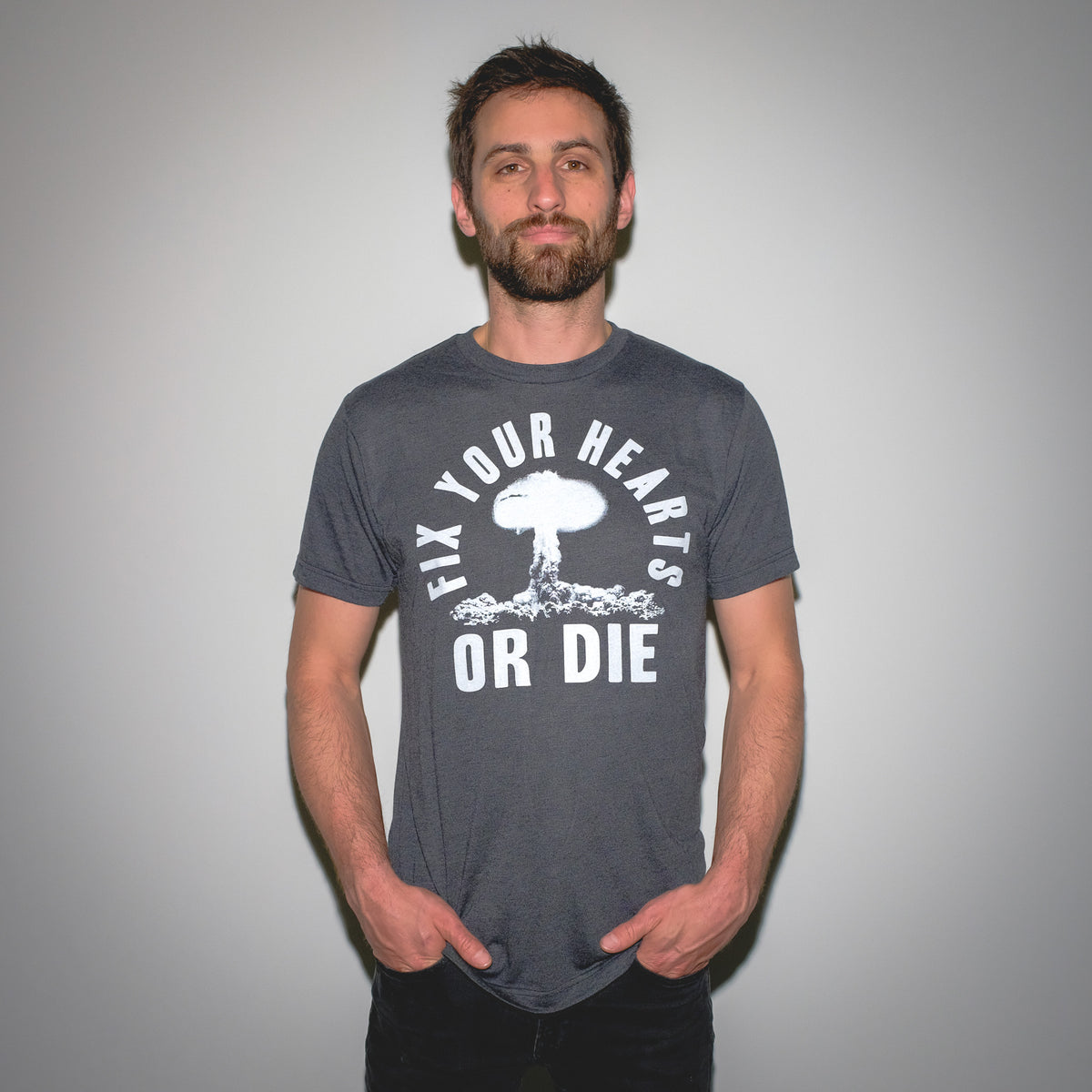 Fix Your Hearts Or Die White Screen Printed Atomic Blast on Black Tri-Blend Black Heather T-Shirt Mysterioso Rock Art Model In Garment