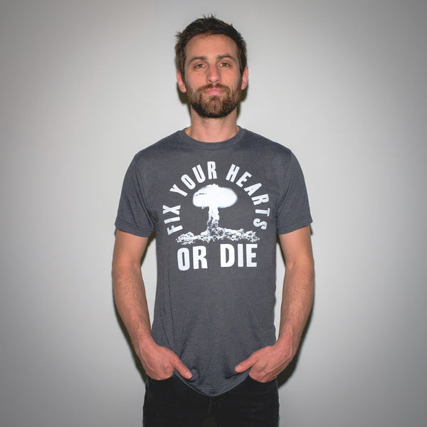 Fix Your Hearts Or Die White Screen Printed Atomic Blast on Black Tri-Blend Black Heather T-Shirt Mysterioso Rock Art Model In Garment