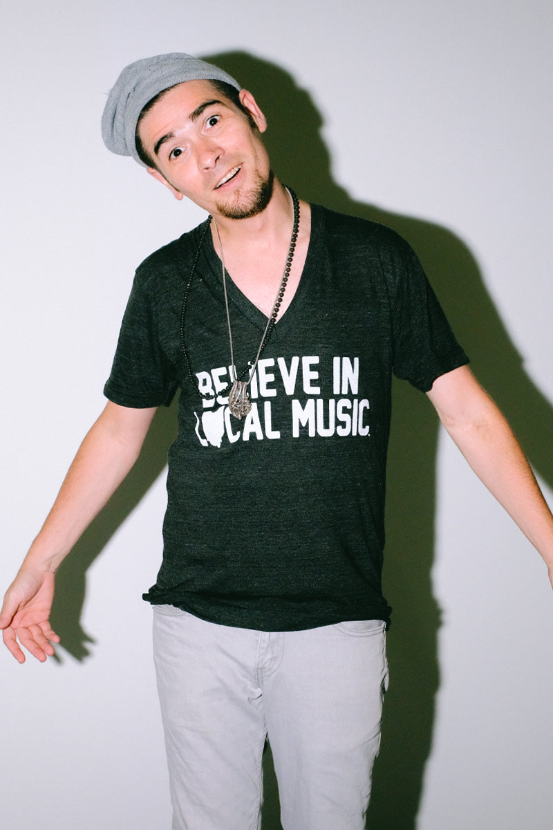 Believe In Local Music in White Print on a Black V-Neck T-Shirt as worn by model Joey Gurwin Mysterioso Rock Art