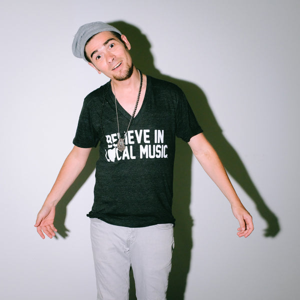 Believe In Local Music in White Print on a Black V-Neck T-Shirt as worn by model Joey Gurwin Mysterioso Rock Art