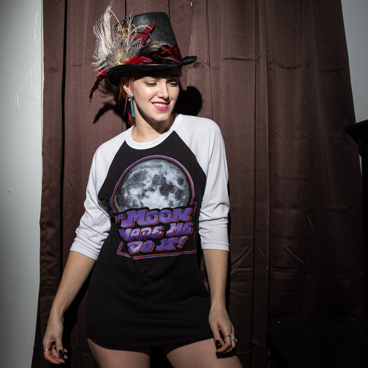 The Moon Made Me Do It Raglan Mysterioso Rock Art Mysterioso Rock Art Bobbi Kitten Damn The Witch Siren Chip Willis Model Wearing 3/4 SLeeve Raglan Baseball T-shirt White Sleeves Black Torso with White, Red, Purple screen print