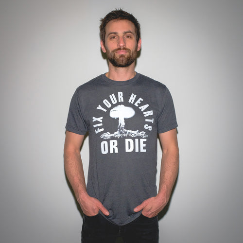 Fix Your Hearts Or Die White Screen Printed Atomic Blast on Black Tri-Blend Black Heather T-Shirt Mysterioso Rock Art Model In Garment